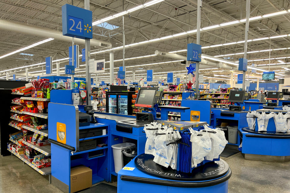 checkout lanes of walmart retail store with view extending far back in the store