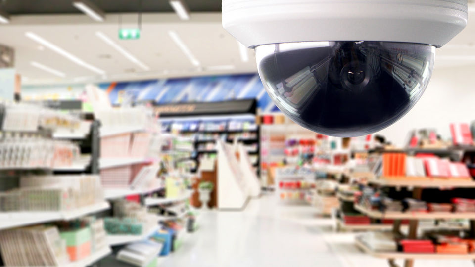 ceiling mounted 360 cctv camera surveilling interior of retail grocery store