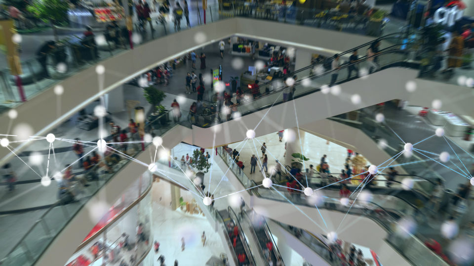 indoor shopping mall view with data network graphic overlay
