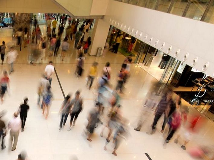 overhead view of shoppers in multi-level retail mall