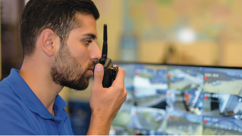 Retail associate talking on walkie talkie