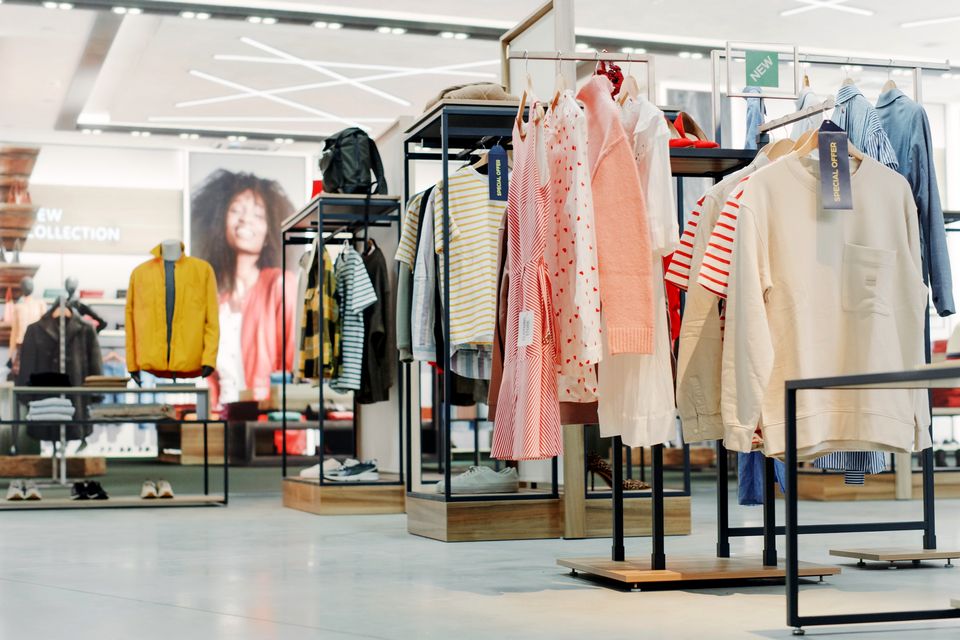 interior of retail apparel store showing off merchandise displays containing items source tagged with rfid inventory sensors