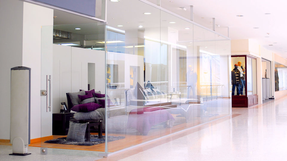 hallway in retail shopping mall showing storefront with two entrances each with theft detection pedestal