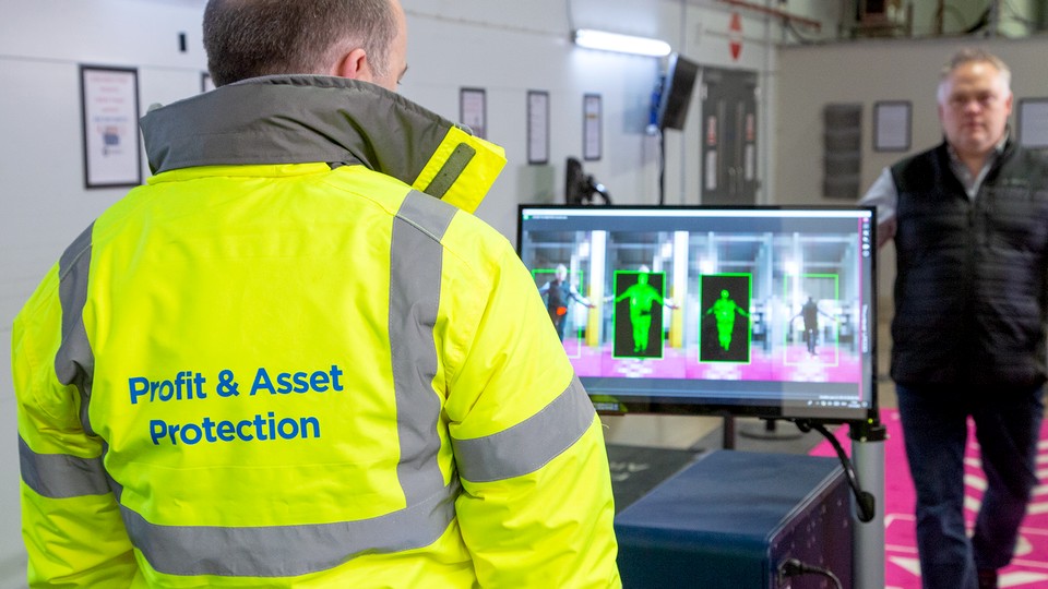 retail loss prevention profit and asset protection worker scanning a potential shopper entering the store