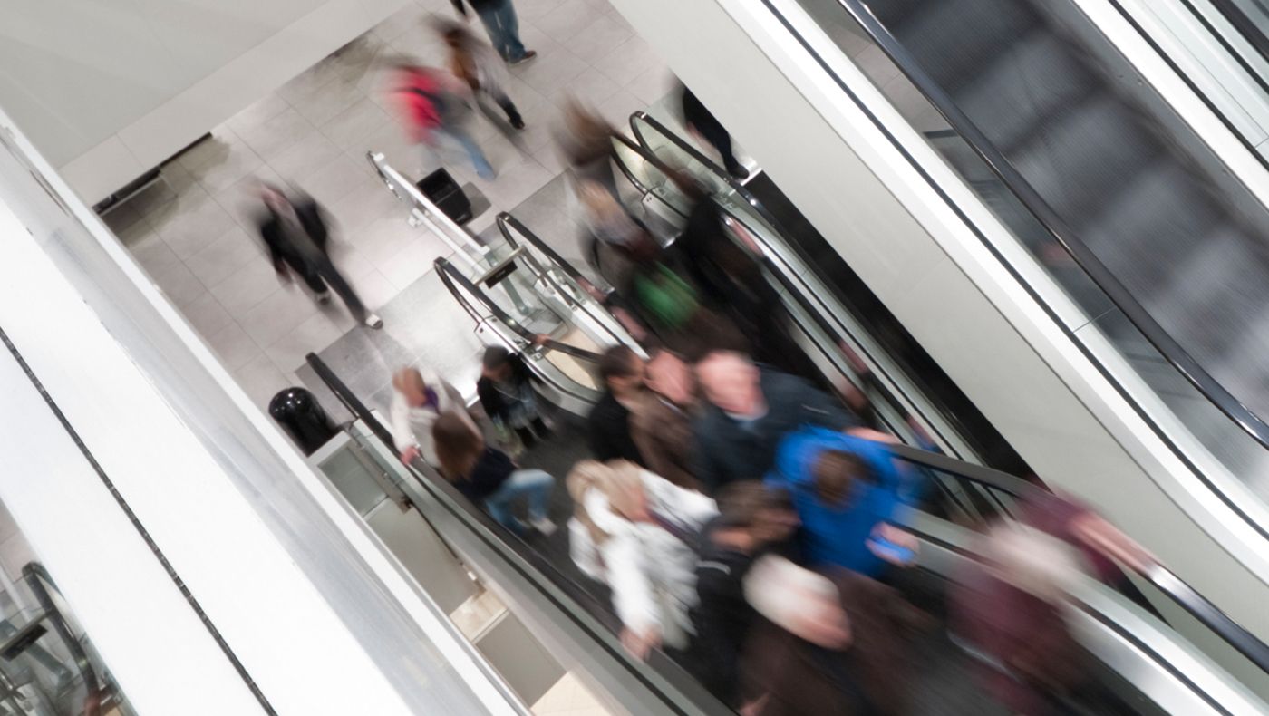 Customers riding on retail store elevator