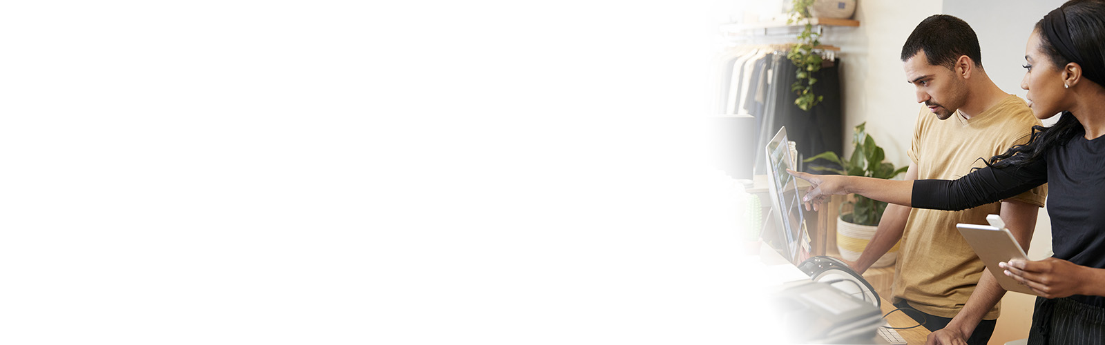 two retail store associates viewing store data on electronic devices