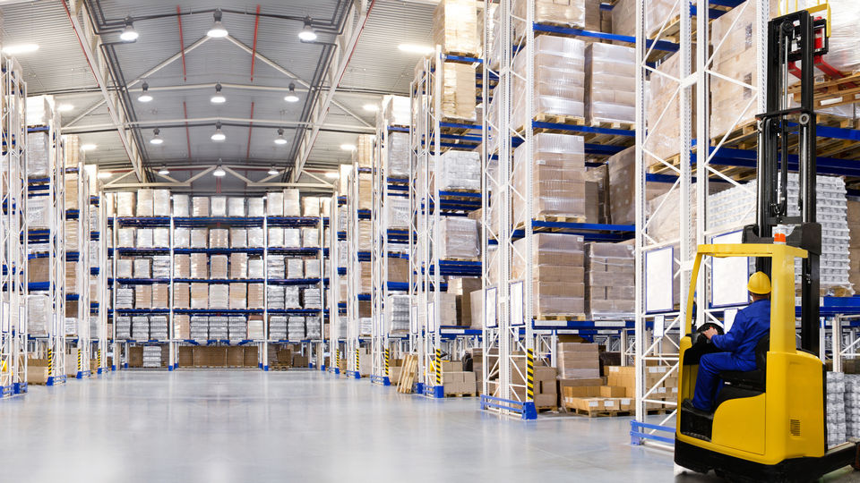 interior of retail warehouse with forklift and operator