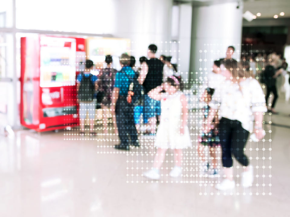 video surveillance camera in retail mall common space with digitized data representation on shoppers