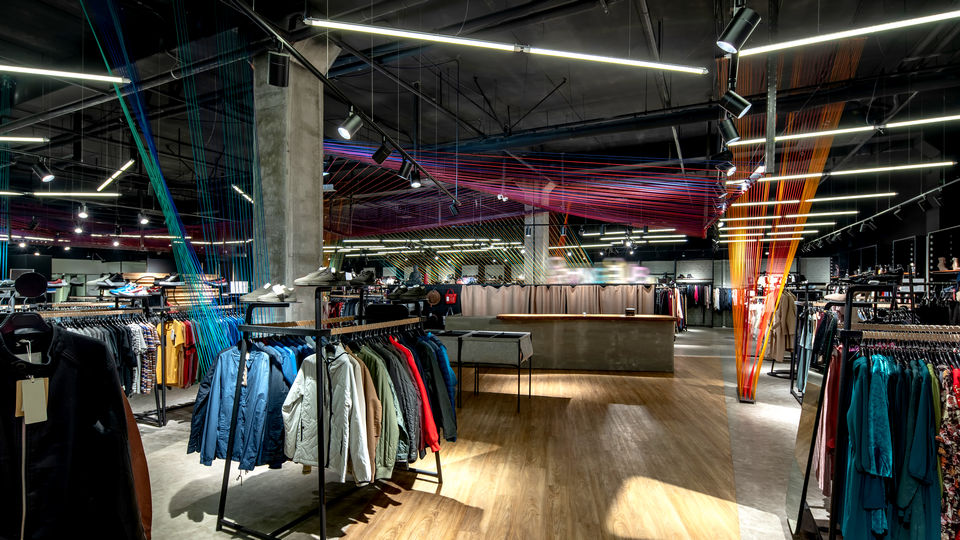 interior view of dramatically lit retail apparel store in a shopping mall